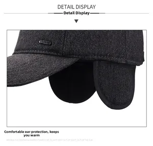 Detail of dark grey wool blend baseball cap with folded ear flaps and SPORT emblem