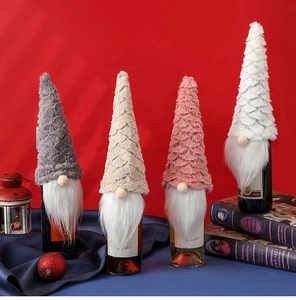 Detailed view of plush faux fur gnome wine bottle covers in gray, beige, pink, and white