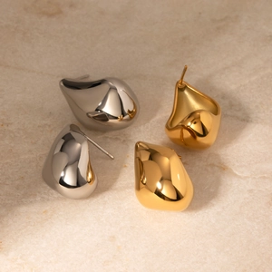 Polished 18k gold and silver stainless steel teardrop earrings on stone surface