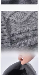 Detailed view of gray cable knit texture and thick plush faux fur lining for warmth
