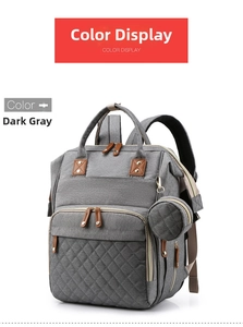 Detail of dark grey quilted diaper bag featuring a round pacifier pouch and leather accents