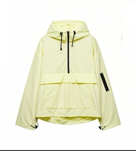 Detail of light yellow hooded anorak jacket with front flap pocket and half-zipper