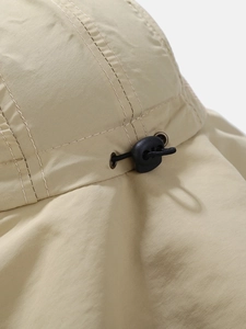 Detailed macro of the adjustable elastic drawstring and metal eyelet on a sun hat