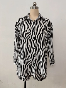 Détail d'une chemise zébrée à manches longues et d'un short assorti à taille élastique