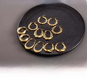 Detailed close-up showing texture of 18K gold plated twisted hoop earrings on display