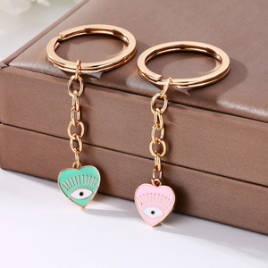 Cute heart shaped Evil Eye keychains with mint green and pink enamel in gold alloy