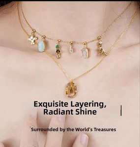 Close-up of layered gold S925 silver necklace with numeric 6 and letter W charms