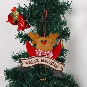 Felt reindeer Christmas ornament with Feliz Navidad wood banner and bells on a tree
