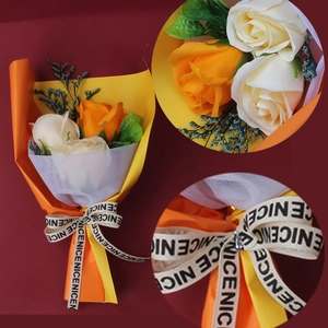 Detail of handmade soap flower bouquet with orange roses and decorative ribbon