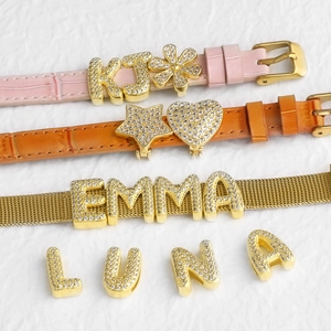 Custom gold zircon letter charms with pink and orange leather bands for personalized bracelets