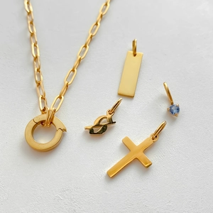 Detail of gold titanium steel cross and gemstone pendants for DIY jewelry making