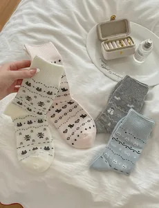 Detail view of four pairs of Fair Isle socks with cute animal and heart patterns