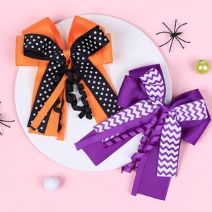 Halloween girls hair clips with double layer orange and purple ribbons on white plate