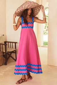 Detail of pink summer maxi dress showing scalloped blue trim on straps and square neckline