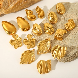 Detailed collection of gold titanium steel earrings with organic geometric textures