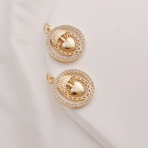 Close-up of gold-plated heart and cross pendants with sparkling cubic zirconia pavé