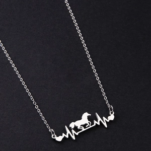 Close-up of silver stainless steel heartbeat necklace with running horse pendant