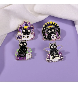 Macro shot of four black cat witch enamel pins on a soft purple background detail
