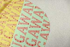 Detail of color-block yellow and green fabric with GAWA letter print and fine stitching