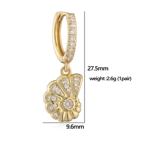 Detail view of gold huggie earrings with shell pendant and zircon stones with measurements