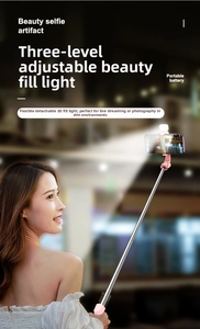 Pink selfie stick featuring a detachable fill light and adjustable phone holder stand