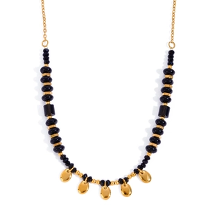 Detail of gold metal droplets and faceted black beads on stainless steel necklace
