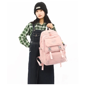 Pink nylon backpack with cute bear prints shown on model for size perspective
