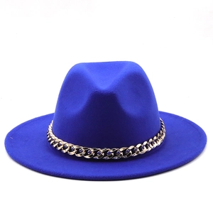 Close-up of royal blue wide-brim fedora hat with a chunky gold chain strap detail
