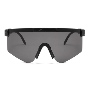 Sporty wraparound cycling sunglasses with black paint-splatter frame and dark grey lens