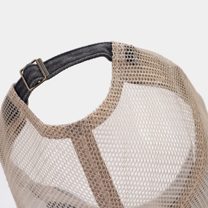 Close-up of khaki mesh and dark grey denim strap with a vintage bronze metal buckle