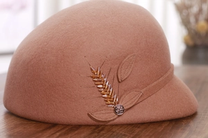 Detailed close-up of crystal wheat ear embroidery on brown wool felt equestrian hat