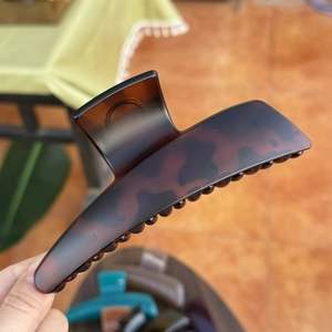 Macro shot of 13.5cm dark brown tortoiseshell hair claw clip with matte finish detail