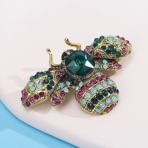 Close-up of vintage bee brooch with crystal rhinestones in bronze finish metal