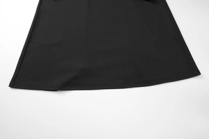 Détail de l'ourlet de la robe noire avec une finition soignée à double couture
