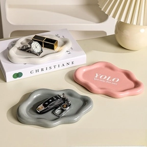 Detailed view of three cloud-shaped ceramic jewelry trays in white, pink, and grey finish
