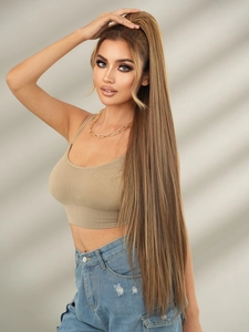 Detail view of smooth 40-inch long straight brown ponytail extension worn by a model