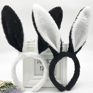 Detail of plush rabbit ear headbands in black and white with soft fuzzy texture
