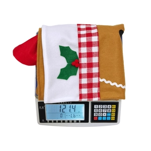 Detail showing gingerbread man chair cover on weight scale measuring 121.4g