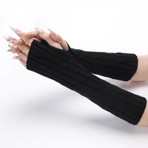 Macro shot of black cable knit arm warmers showing texture and fingerless design