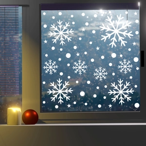 Detailed view of white snowflake static window decals with warm candle lighting decorations