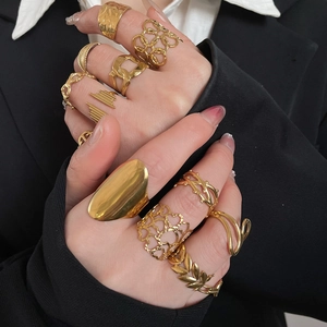 Close-up of heart-shaped hollow rings on fingers with a minimalist aesthetic style