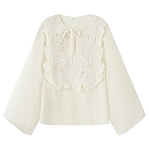 White embroidered long sleeve top with lace crochet detail and ruffle trim in flat lay