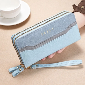 Detailed shot of long dual-zipper wallet in color-block blue with lychee texture