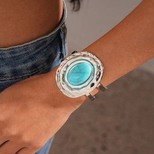 Detail view of Bohemian wide silver cuff bracelet with a large oval blue turquoise stone