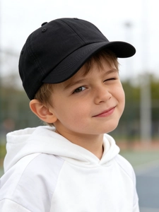 Outdoor shot of classic black cotton twill baseball cap for kids with high texture detail