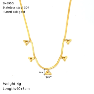 Macro shot of 18K gold plated triangle pendant on a sleek snake chain necklace