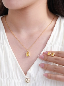 Elegant gold-plated jewelry set with square yellow zircon stones shown on a model