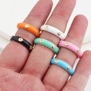 Detailed view of colorful enamel stackable rings with AAA cubic zirconia on a model hand