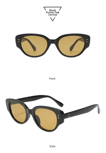 Detail of Y2K black cat eye sunglasses with tea lenses and silver rivet accents