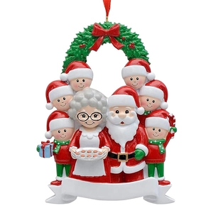 Detailed resin Christmas ornament with Santa, family figures, and red ribbon hanging loop
